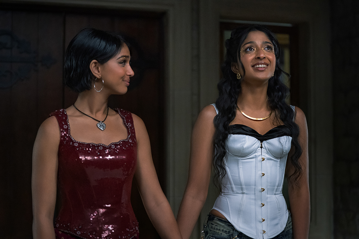&Quot;Two Young Women Dressed Up For An Event Stand Indoors, Holding Hands. One Wears A Red Sequined Dress, The Other A White Corset Top. They Appear Happy And Are Looking At Each Other, Suggesting Friendship Or Excitement.&Quot;