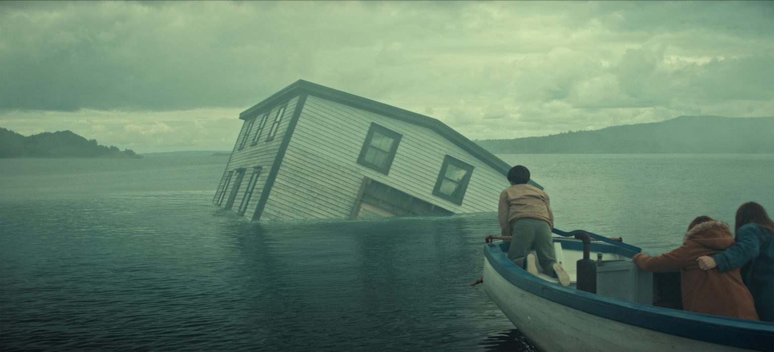 &Quot;A Partially Submerged House Tilts In A Misty Lake As Three People In A Small Boat Observe, With Cloudy Skies And Distant Hills Creating A Dramatic, Mysterious Atmosphere.&Quot;